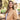Woman in a tan blazer standing outdoors with trees in the background
