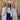 Three women posing together against a wooden background