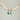 Turquoise earrings hanging from a branch against a gray background