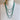 Necklace on a mannequin with 'Wolf Form Co.' label against a plain background