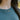Close-up of the Frankie interlocking ring necklace worn with a teal sweater
