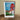 Framed artwork of a sign for 'Famous El Rancho' on a wooden surface.