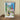Framed artwork of a motel scene on a wooden surface