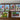 Set of six framed artworks depicting vintage signs and scenes on a wooden surface.