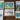 Set of six framed artworks depicting landscapes and cityscapes on a wooden surface.