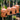 Four terracotta hanging lanterns with star patterns against a blurred natural background