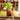 Ceramic bell hanging on a wooden table with a blurred garden background