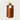 Brown leather key holder with gold ring on a light gray background