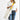 Person holding a white tote bag with a yellow strap on a white background