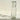 Clear glass bottle with engraved design on a textured surface