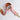 Pink leather strap with gold hardware on a white background