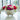 Floral arrangement in a decorative bowl on a reflective surface with a blurred background