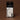 Pack of three Ranger Station Tobacco + Musk car air fresheners in dark olive color, sealed in clear plastic with a black header card, set against a solid dark brown background.