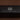 A close-up of a black rectangular box with white text reading 'RANGER STATION' and smaller text below, 'YOUR DAILY DOSE OF FRAGRANCE! - TEDDY NOSEVELT', set against a dark brown background.