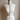 Jett lariat worn as a choker with the ends knotted and hanging long to the waist on a dress form