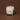 White candle in a glass container with a logo on a brown background