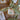 Decorative cookies with green ribbons on a wooden surface