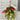 Decorative mistletoe ornament with a red ribbon on a cutting mat.